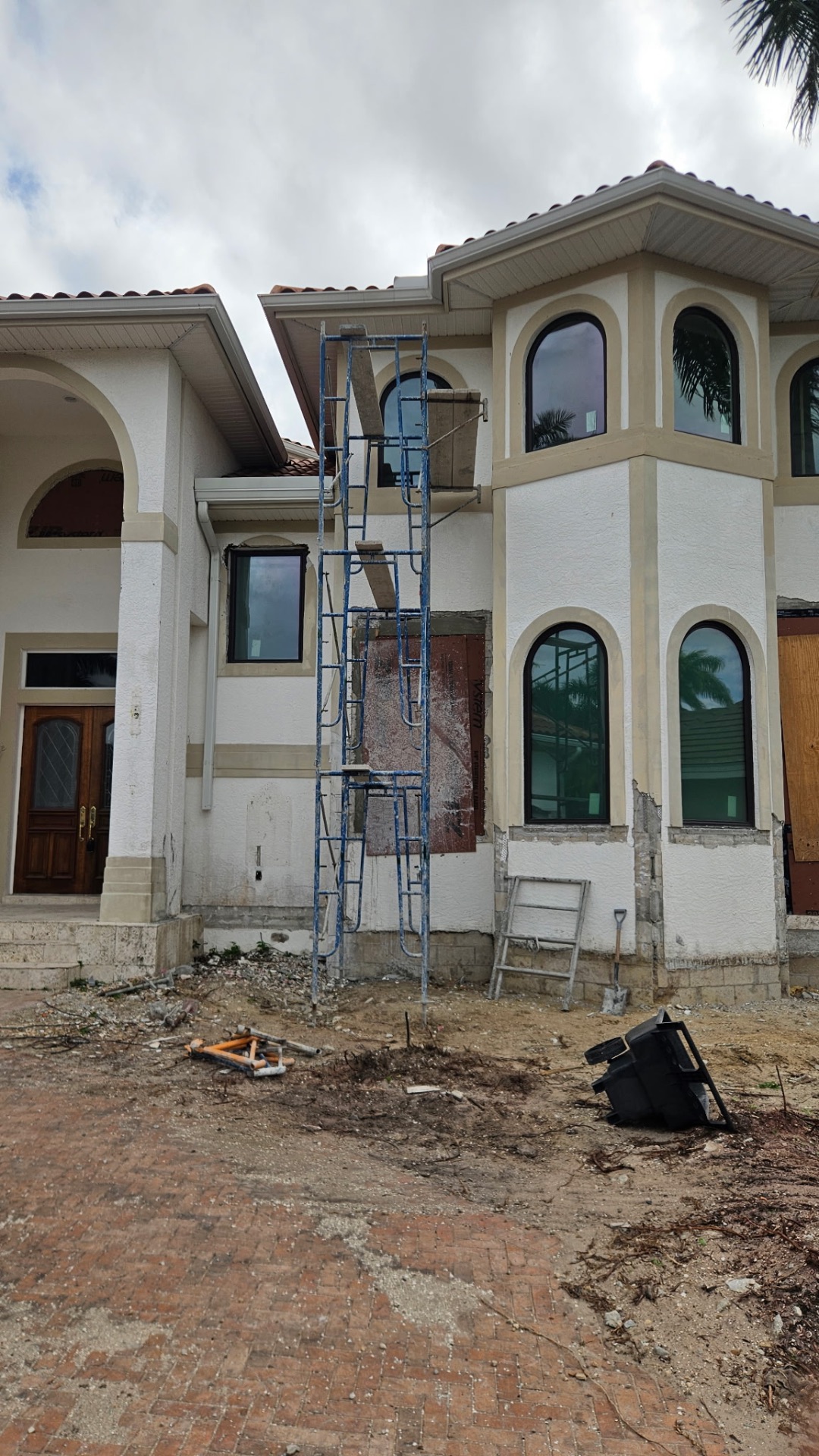 Exterior wall repair and refinishing in progress
